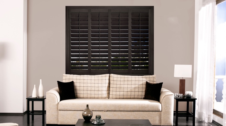 Fort Myers sitting room with stained wood shutters.